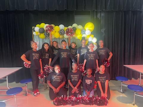 A group of cheerleaders posing for a photoDescription automatically generated